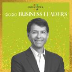 A man in suit and tie standing next to the words indiaspora 2 0 2 0 business leaders.