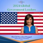A woman standing in front of an american flag.