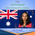 A woman standing in front of an australian flag.