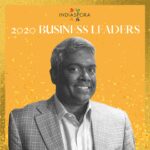 A man in a suit and tie standing next to the words indiaspora 2 0 2 0 business leaders.