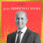A man in suit and tie standing next to the words indiaspora 2 0 2 0 business leaders.