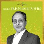 A man in suit and glasses standing next to the words indiaspora 2 0 2 0 business leaders.