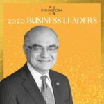A man in suit and tie standing next to the words indiaspora 2 0 2 0 business leaders.