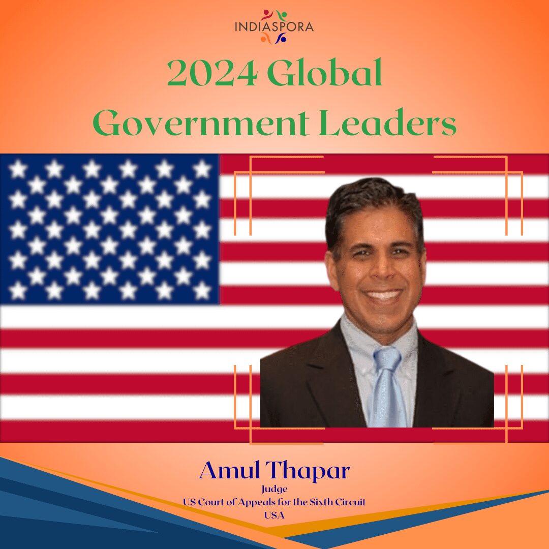 A picture of amul thapar with the american flag.
