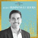 A man in suit and tie standing next to the words indiaspora 2 0 2 0 business leaders.