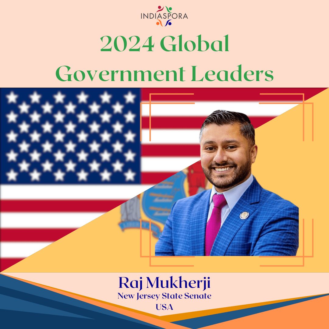 A man in a suit and tie next to an american flag.