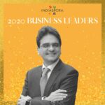 A man with his arms crossed standing in front of the words indiaspora 2 0 2 0 business leaders.