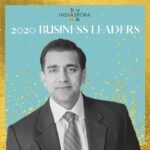 A man in suit and tie standing next to the words indiaspora 2 0 2 0 business leaders.