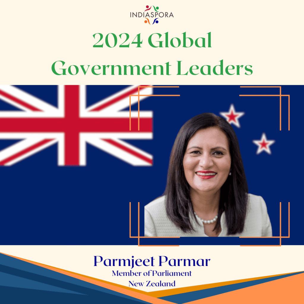 A woman standing in front of the flag of new zealand.