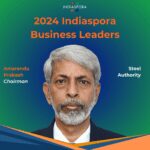 A man with grey hair and beard wearing suit.