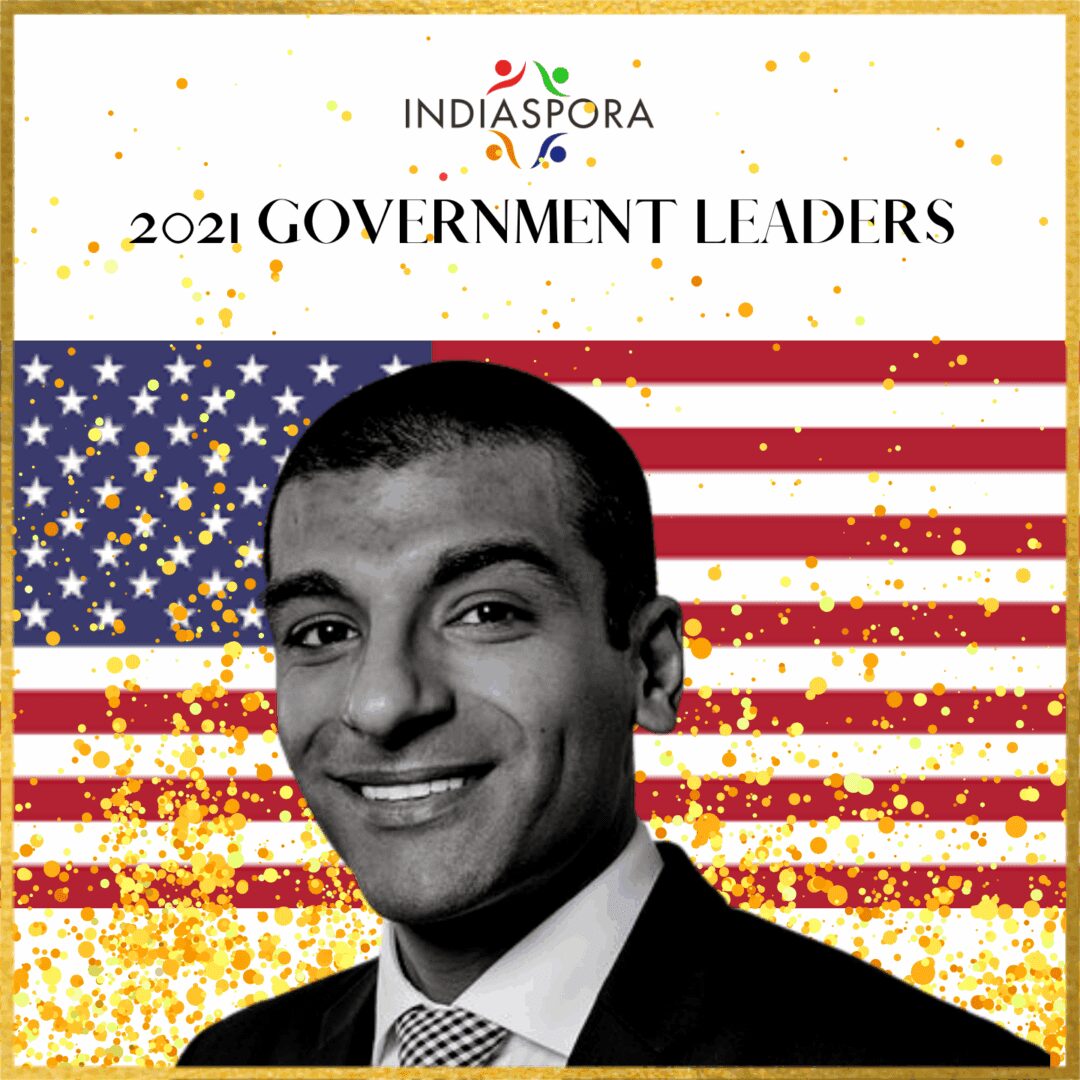 A man in suit and tie with american flag background