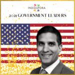 A man in front of an american flag.