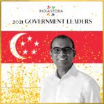 A man standing in front of the singapore flag.
