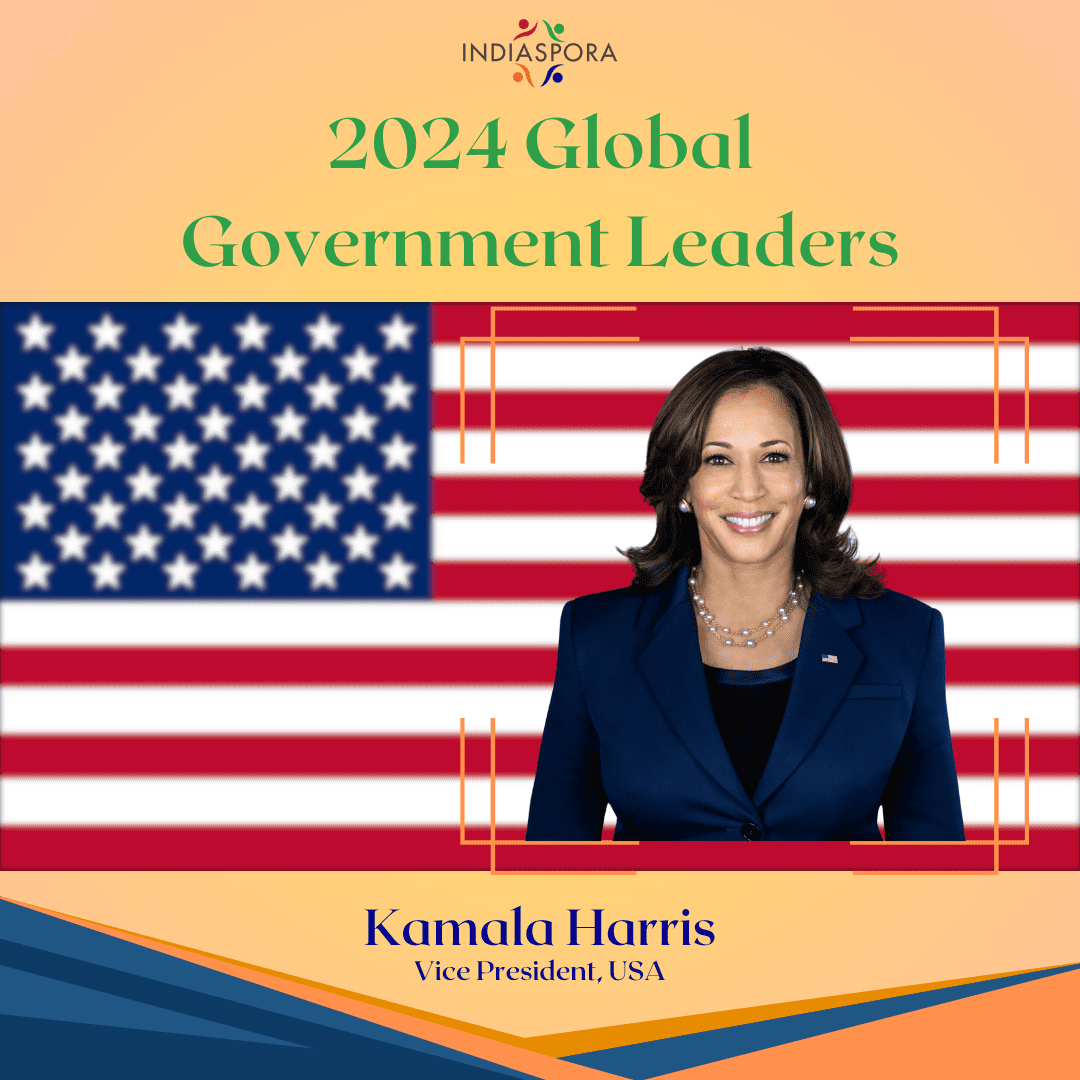 Kamala harris is the first woman to lead a major political party.|A woman in a suit and necklace standing next to an american flag.