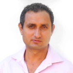 A man in pink shirt and black hair.