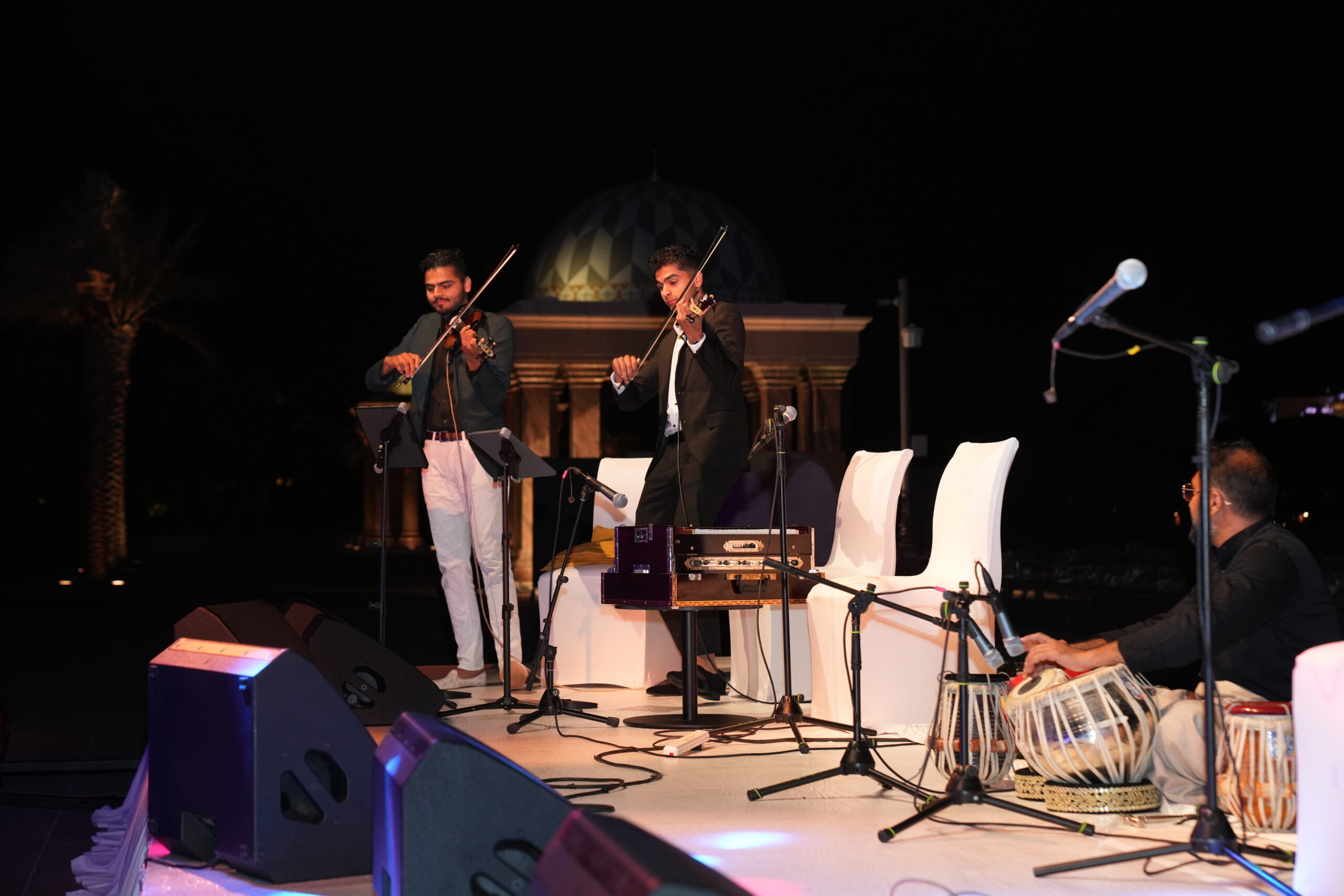 A group of people playing musical instruments on stage.