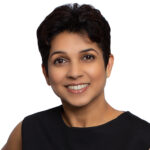 A woman with short hair is smiling for the camera.