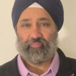 A man with a beard and mustache wearing a turban.