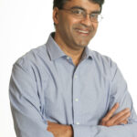 A man with glasses and a blue shirt