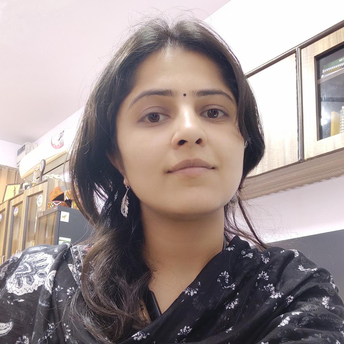 A woman with long hair wearing a black shirt.