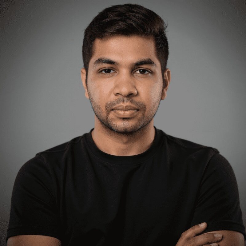 A man with his arms crossed wearing a black shirt.