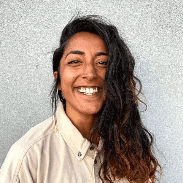 A woman with long hair smiles for the camera.