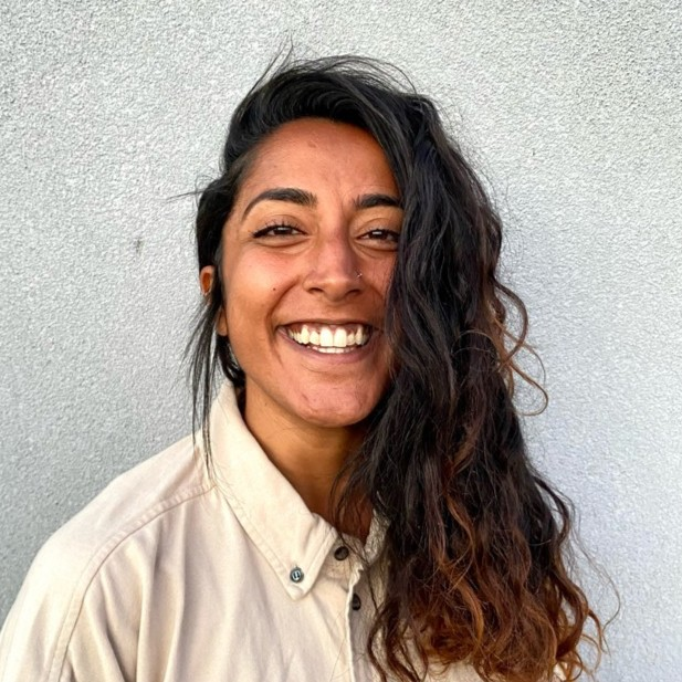 A woman with long hair smiles for the camera.