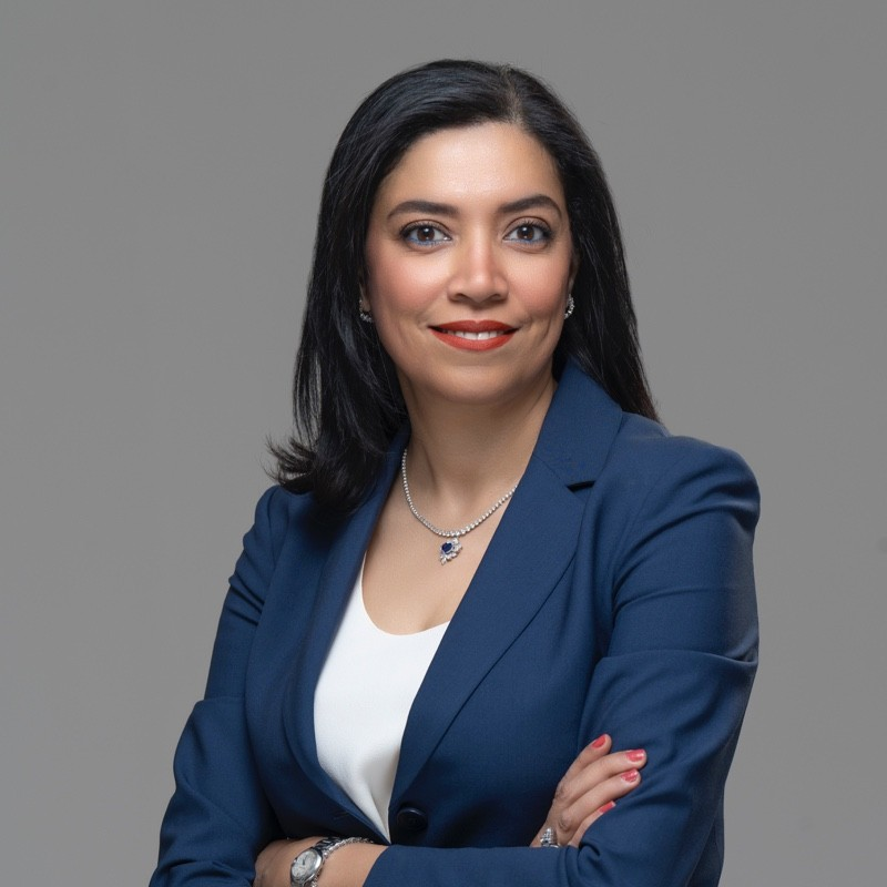 A woman in a blue jacket posing for the camera.