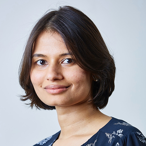 A woman with short hair is smiling for the camera.