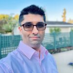 A man with glasses and a blue shirt
