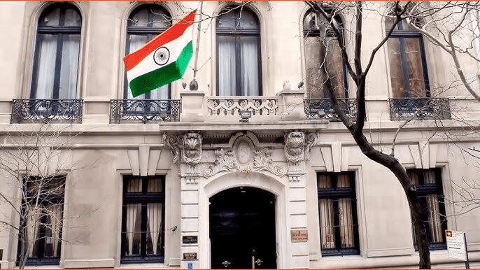 Building with Indian flag outside, winter trees.