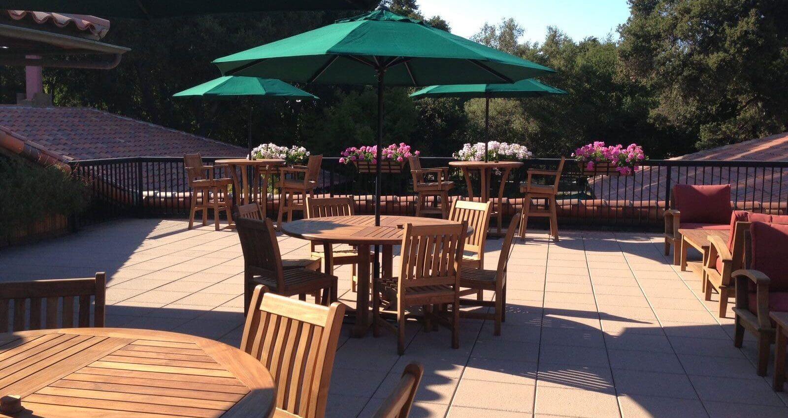Outdoor patio with tables and umbrellas.