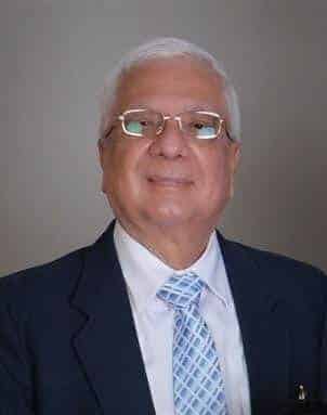 A man in a suit and tie wearing glasses.