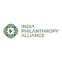 India philanthropy alliance logo|A man in black shirt and white background|A man with glasses and a blue vest