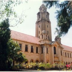 A large building with a tall tower in the middle of it.
