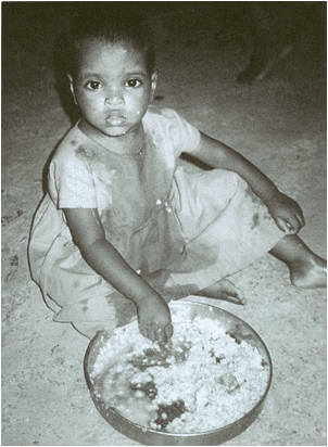 A young child sitting on the ground with food in front of him.|A young child sitting on the ground with food in front of him.|A chart showing the growth of thrive scale.|A group of people sitting on steps in front of a building.