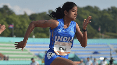 A woman running in an indian team uniform.|A group of young people playing baseball on the field.|A person standing in the dirt with a horse behind them.|A person standing in the dirt with a horse behind them.|A female athlete running on the track in an india uniform.|A woman holding up her arms while standing on top of a track.|A person running on some steps in the day.