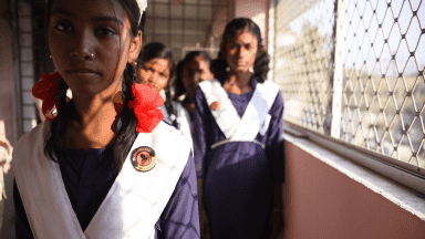 A group of girls standing next to each other.