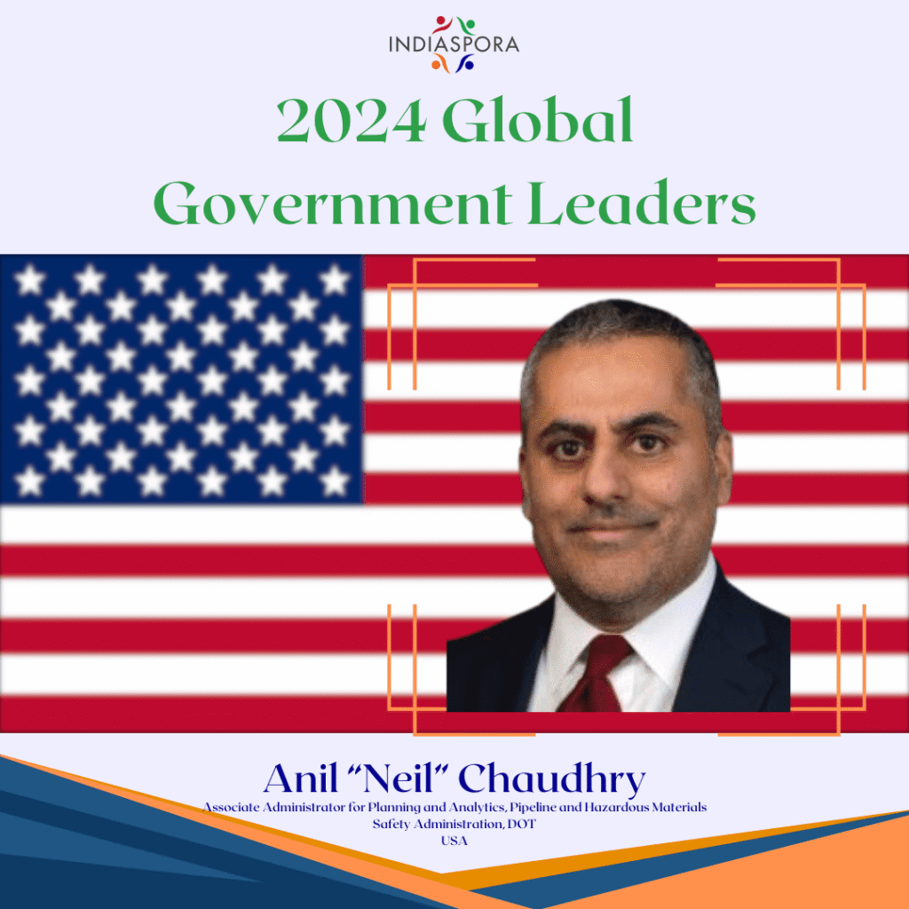 A picture of anil chaudhry with the american flag behind him.