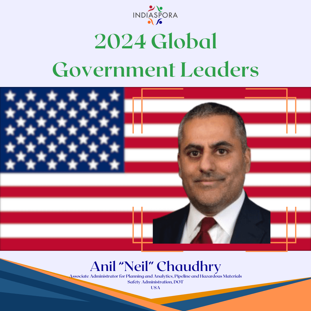 A picture of anil chaudhry with the american flag behind him.