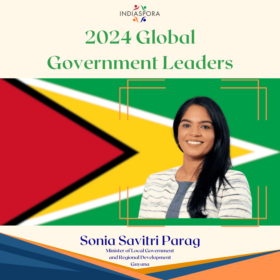 A woman standing in front of the flag of guyana.