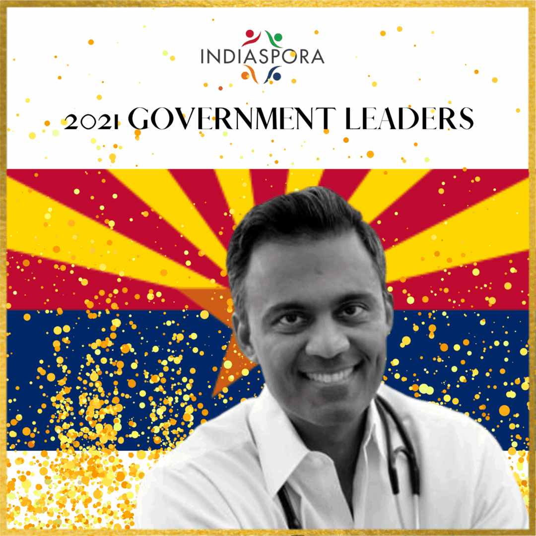 A man with stethoscope standing in front of arizona flag.