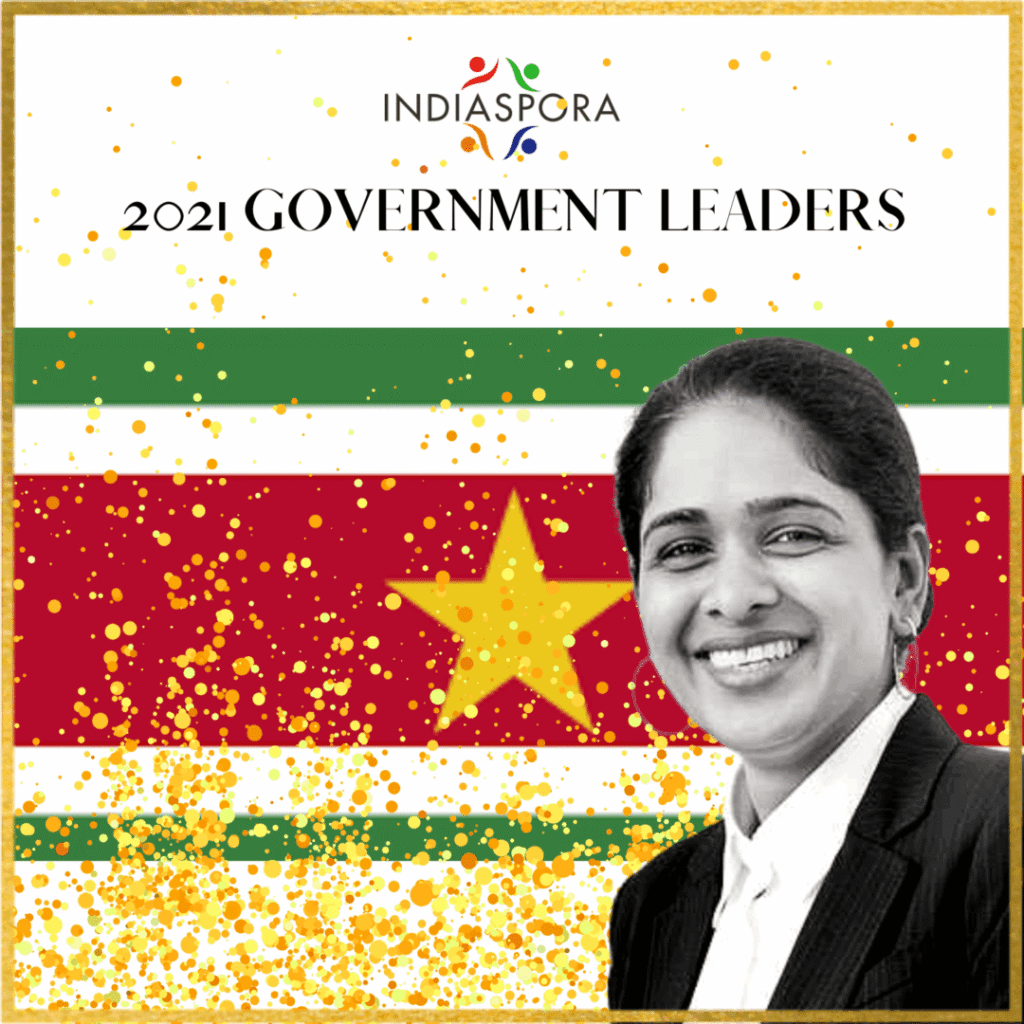 A woman standing in front of an indian flag.
