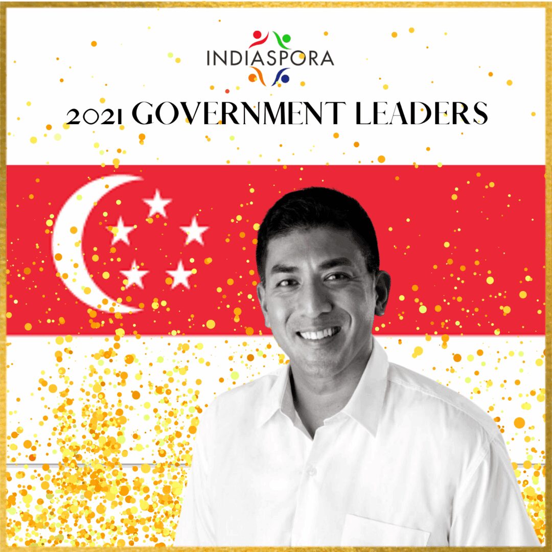 A man standing in front of the singapore flag.