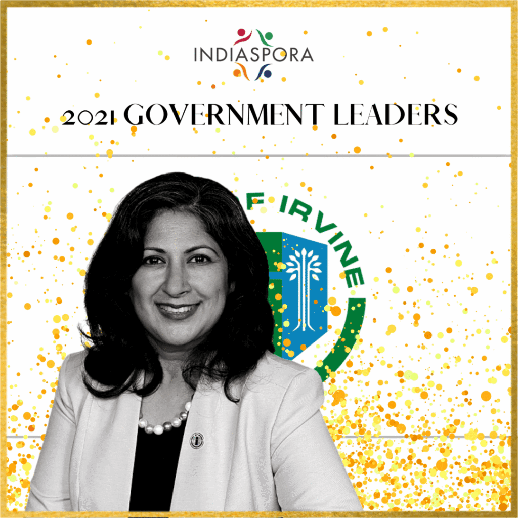 A woman standing in front of the government leaders logo.