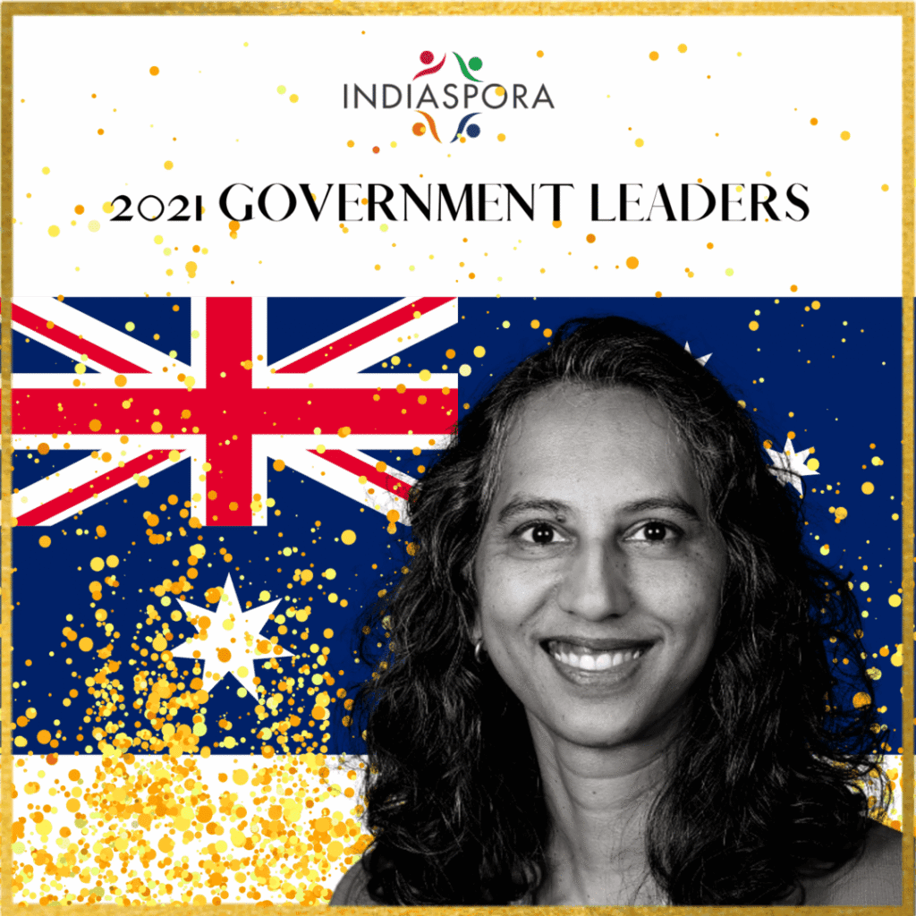 A woman standing in front of an australian flag.