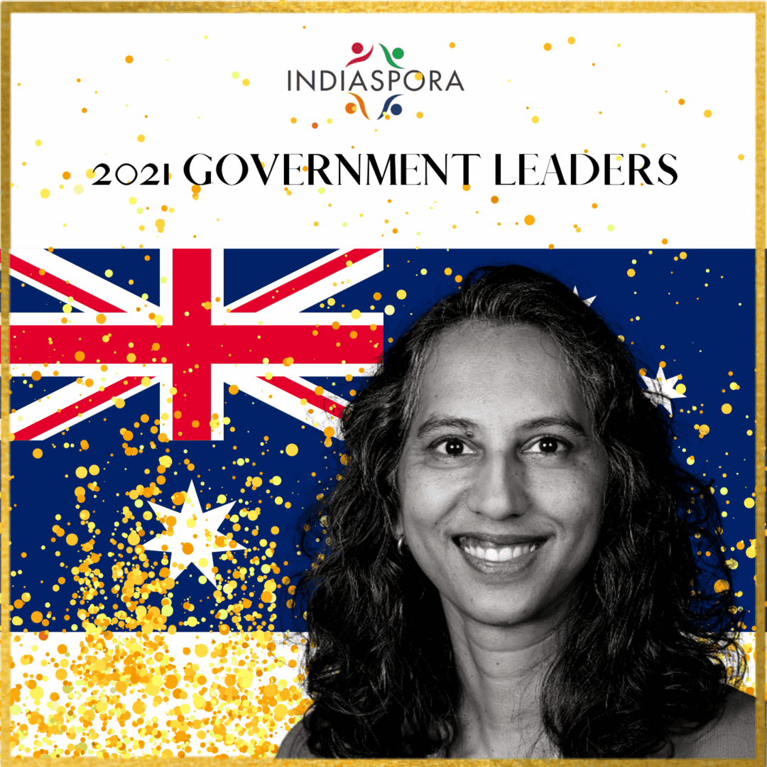 A woman standing in front of an australian flag.