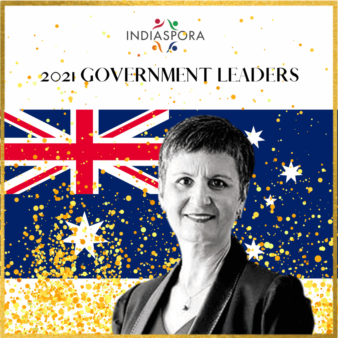 A woman standing in front of an australian flag.