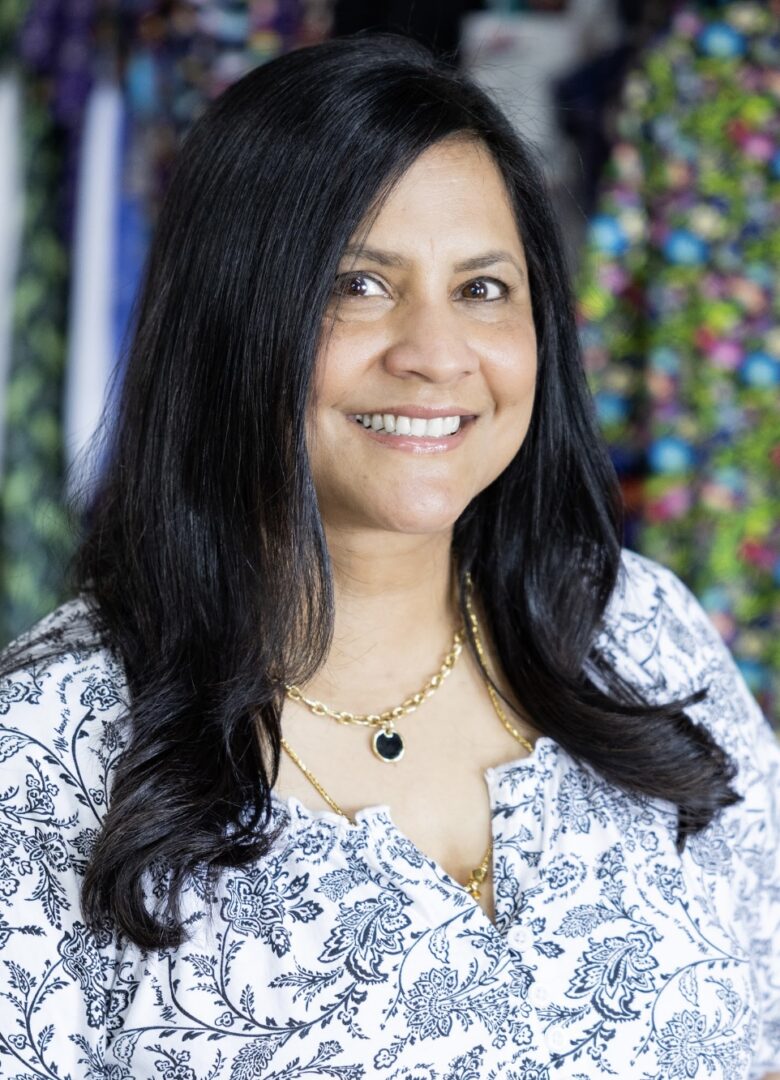 Smiling woman with long dark hair.
