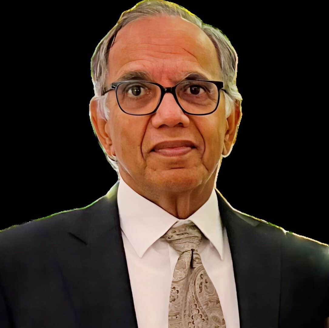 A man in suit and tie with glasses.